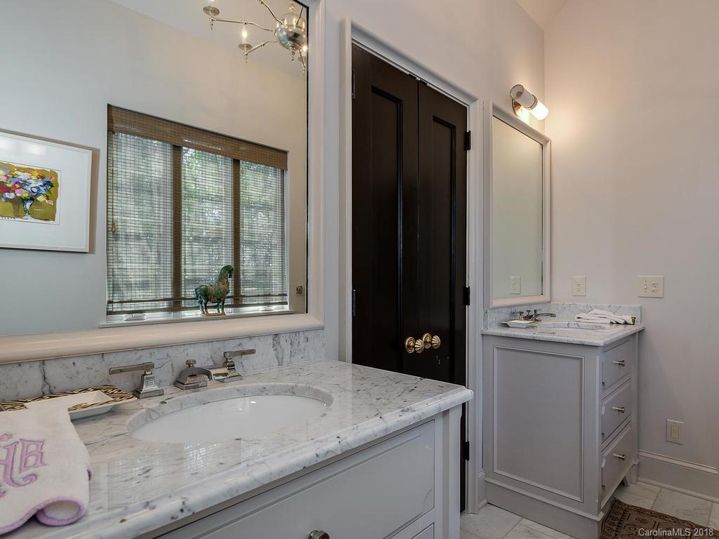 661 Colville Road Charlotte, NC 28207 - Photo 18 of 36 a bathroom with a granite countertop sink and a mirror