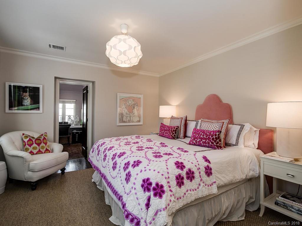 661 Colville Road Charlotte, NC 28207 - Photo 22 of 36 a bedroom with bed and a chandelier