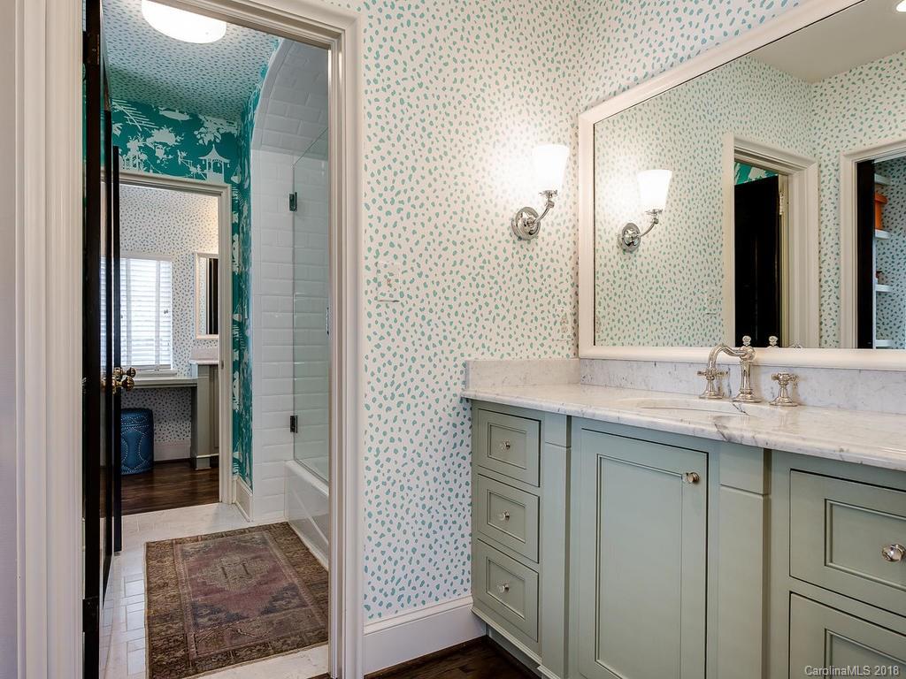 661 Colville Road Charlotte, NC 28207 - Photo 24 of 36 a en suite bathroom with a granite countertop sink and a mirror