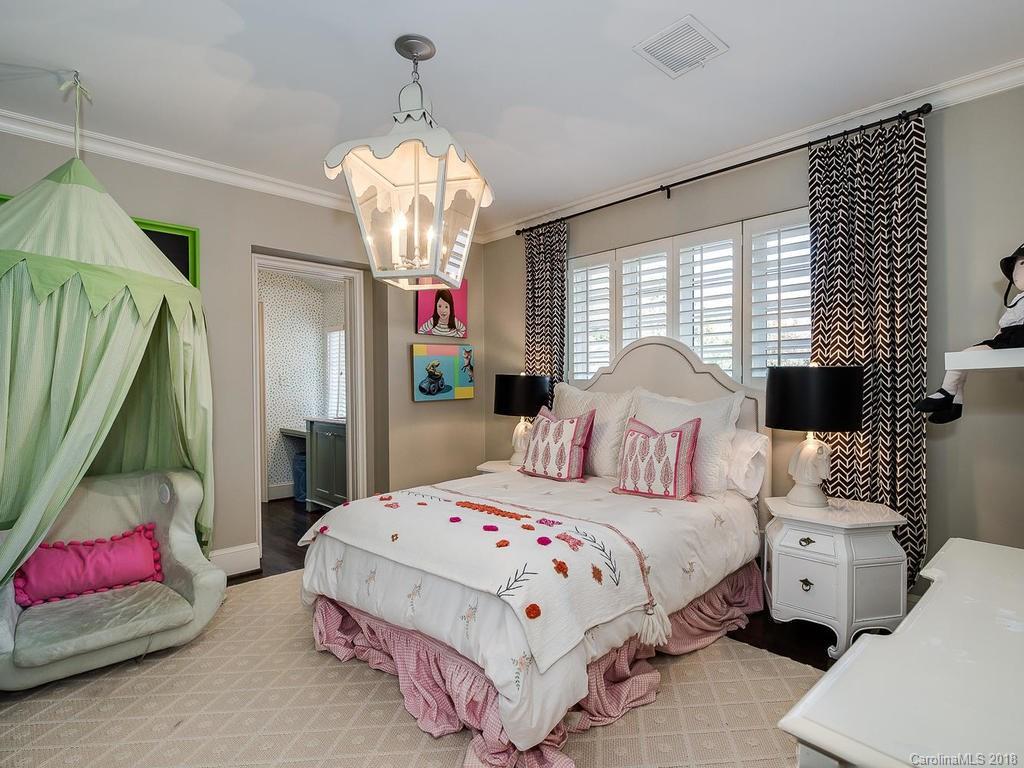 661 Colville Road Charlotte, NC 28207 - Photo 25 of 36 a bedroom with bed and a chandelier
