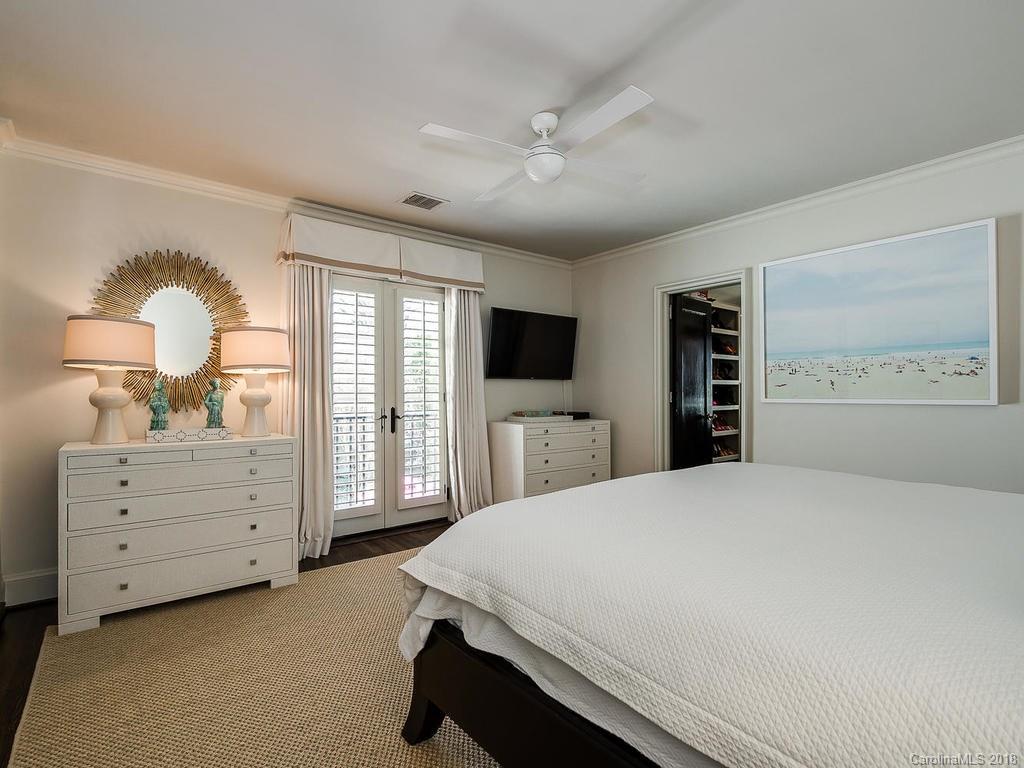 661 Colville Road Charlotte, NC 28207 - Photo 27 of 36 a bed room with a bed and a television