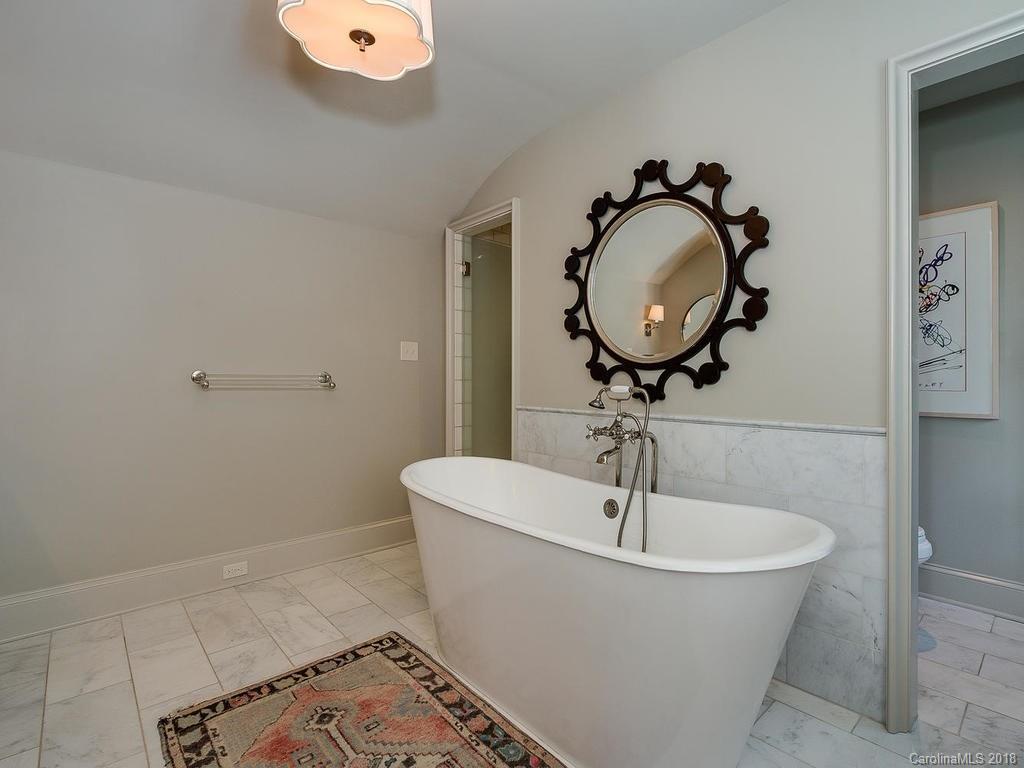 661 Colville Road Charlotte, NC 28207 - Photo 28 of 36 a bathroom with a sink and mirror