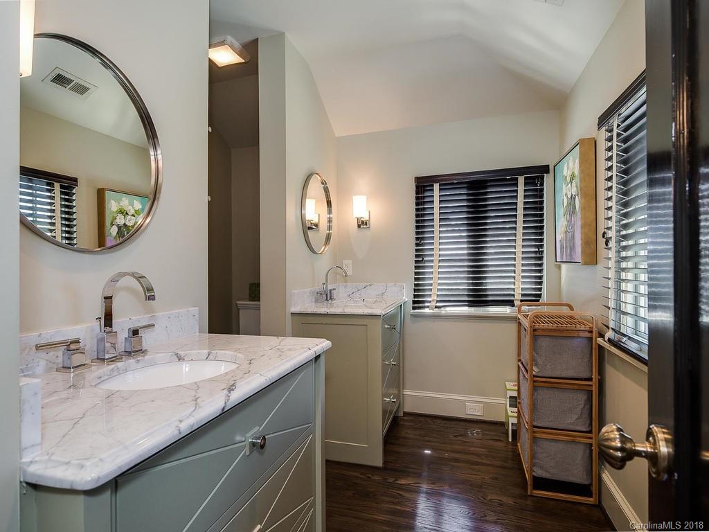 661 Colville Road Charlotte, NC 28207 - Photo 31 of 36 a bathroom with a sink and a mirror