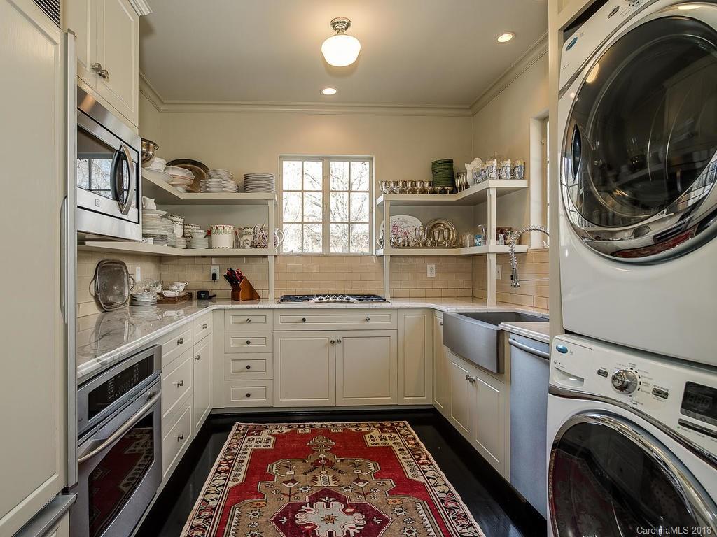 661 Colville Road Charlotte, NC 28207 - Photo 8 of 36 a utility room with cabinets dryer and washer