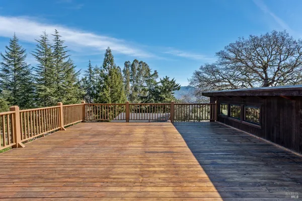a view of a terrace with wooden floor and iron stairs