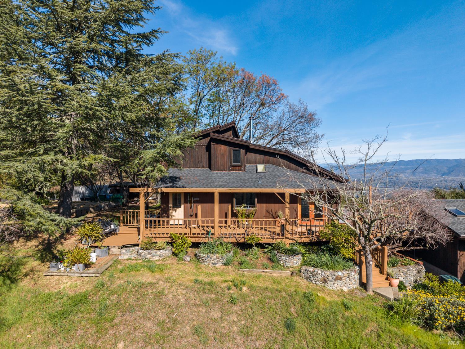 1411 Oak Knoll Road Ukiah, CA 95482 - Photo 39 of 45 a front view of a house with a yard table and chairs