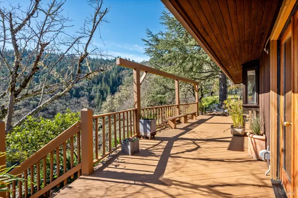 a view of balcony with wooden floor and fence