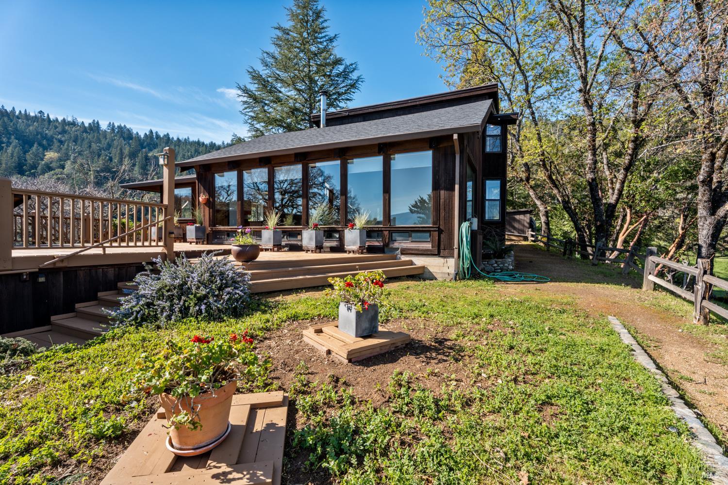 1411 Oak Knoll Road Ukiah, CA 95482 - Photo 6 of 45 a backyard of a house with yard fountain and outdoor seating