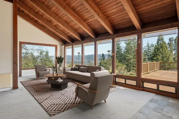 a living room with furniture and a floor to ceiling window