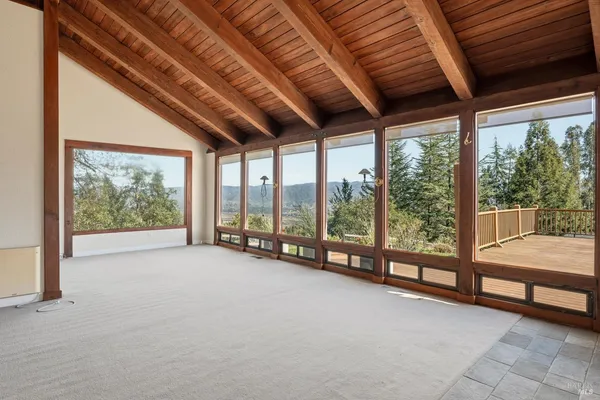 a view of an empty room with windows and city view