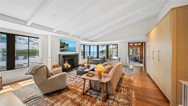 a living room with fireplace furniture and a large window