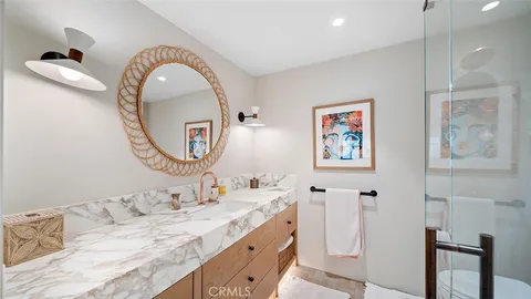 a bathroom with a granite countertop double vanity sink and a mirror