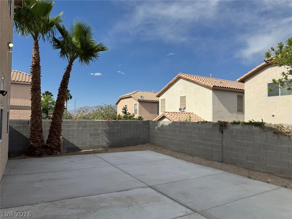 3962 Coyote Ridge Court Las Vegas, NV 89129 - Photo 3 of 35 A spacious backyard patio provides ample space for relaxation or entertaining in this vibrant outdoor setting.