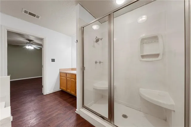 a bathroom with a shower a toilet and a sink