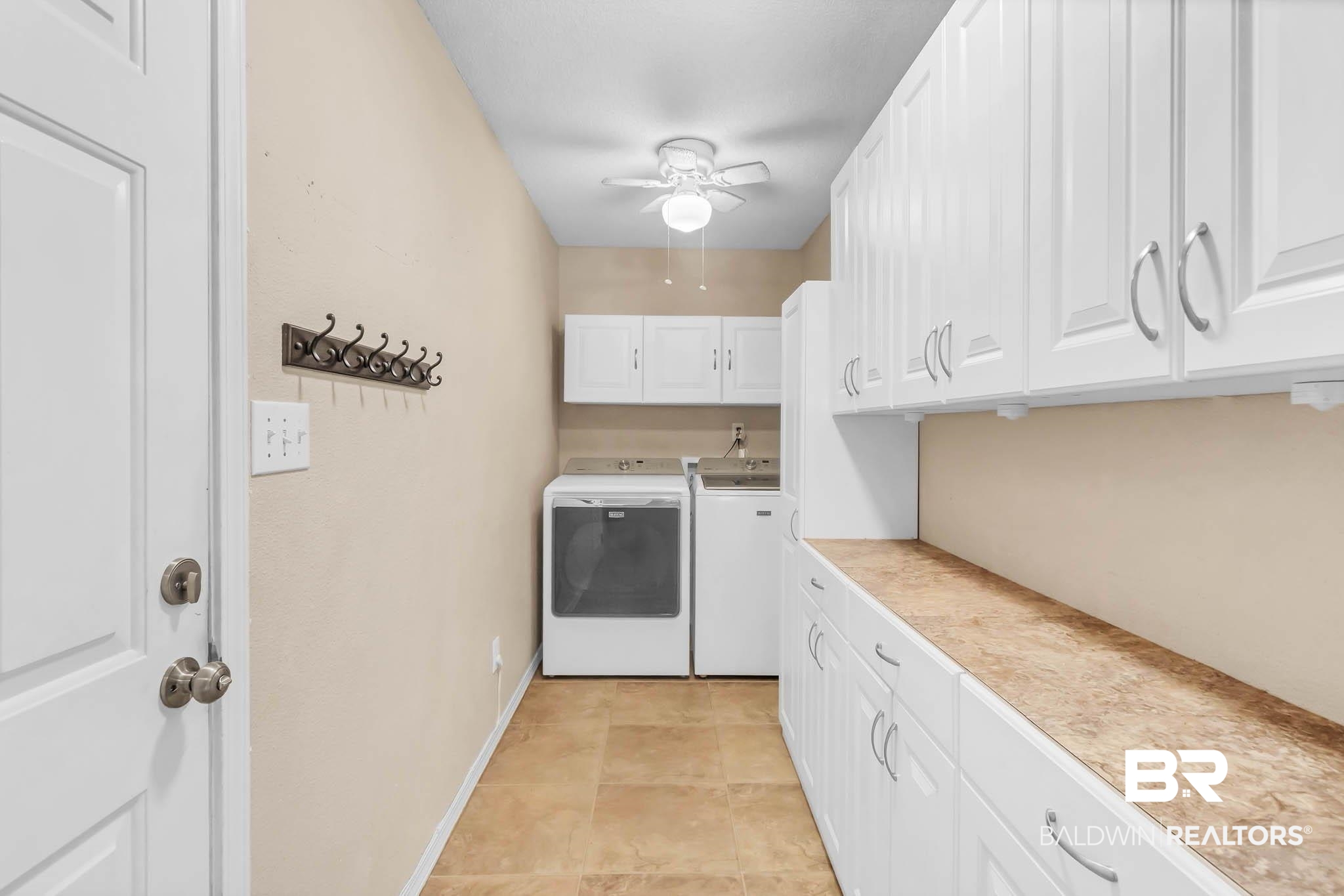 9607 Czar Court Fairhope, AL 36532 - Photo 31 of 42 Laundry area featuring cabinet space, washer and dryer, a ceiling fan, and light tile patterned flooring