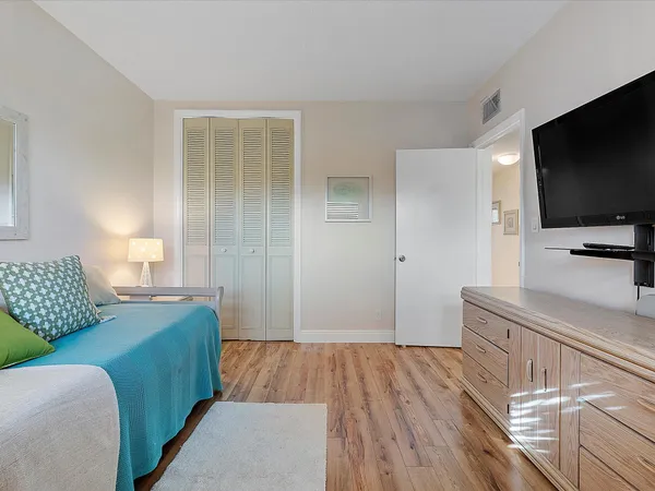 a bedroom with a bed and a flat screen television