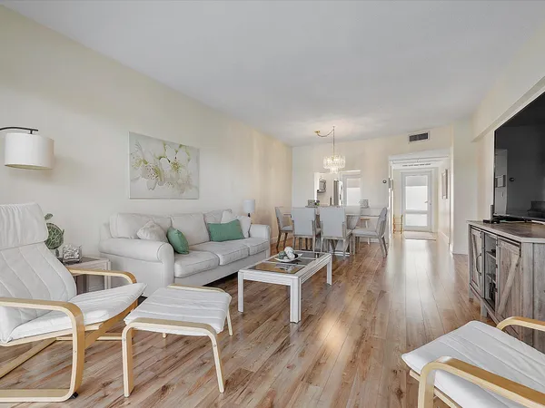 a living room with furniture wooden floor and a flat screen tv