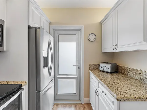 a kitchen with stainless steel appliances granite countertop a refrigerator and a stove