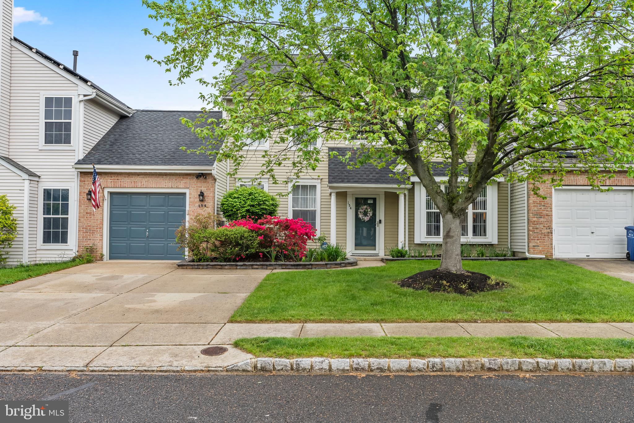 154 Sharpless Boulevard Westampton, NJ 08060 - Photo 2 of 22 a front view of a house with a garden and trees