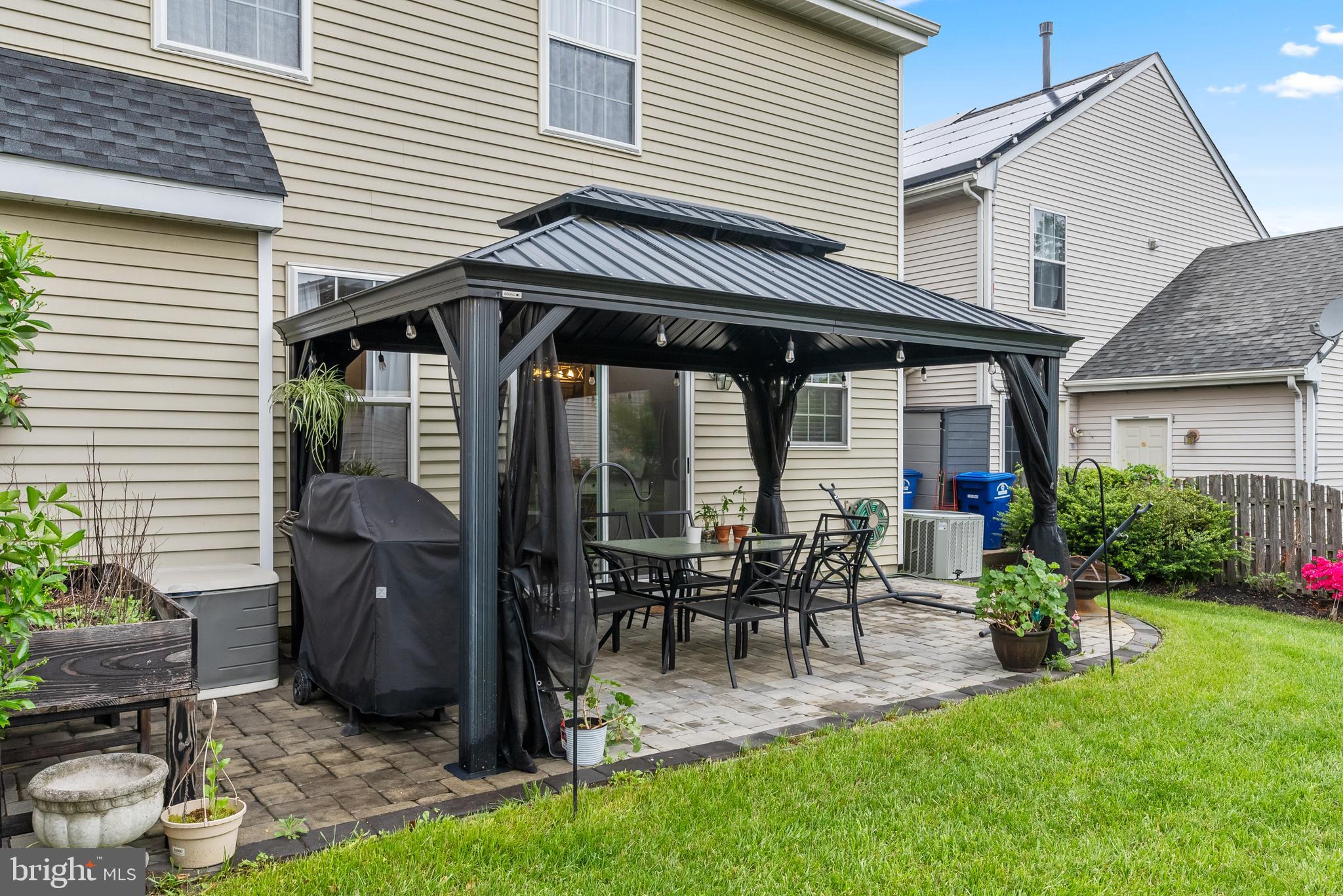 154 Sharpless Boulevard Westampton, NJ 08060 - Photo 22 of 22 a view of a patio with table and chairs potted plants and floor to ceiling window