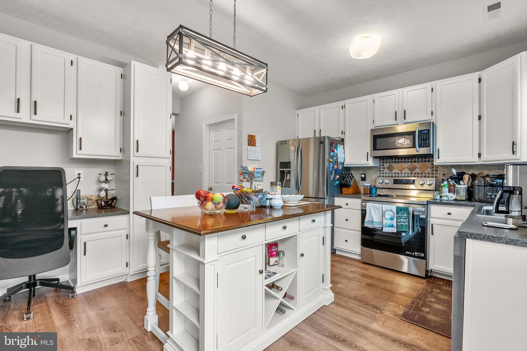 154 Sharpless Boulevard Westampton, NJ 08060 - Photo 7 of 22 a kitchen with stainless steel appliances a stove refrigerator sink and cabinets