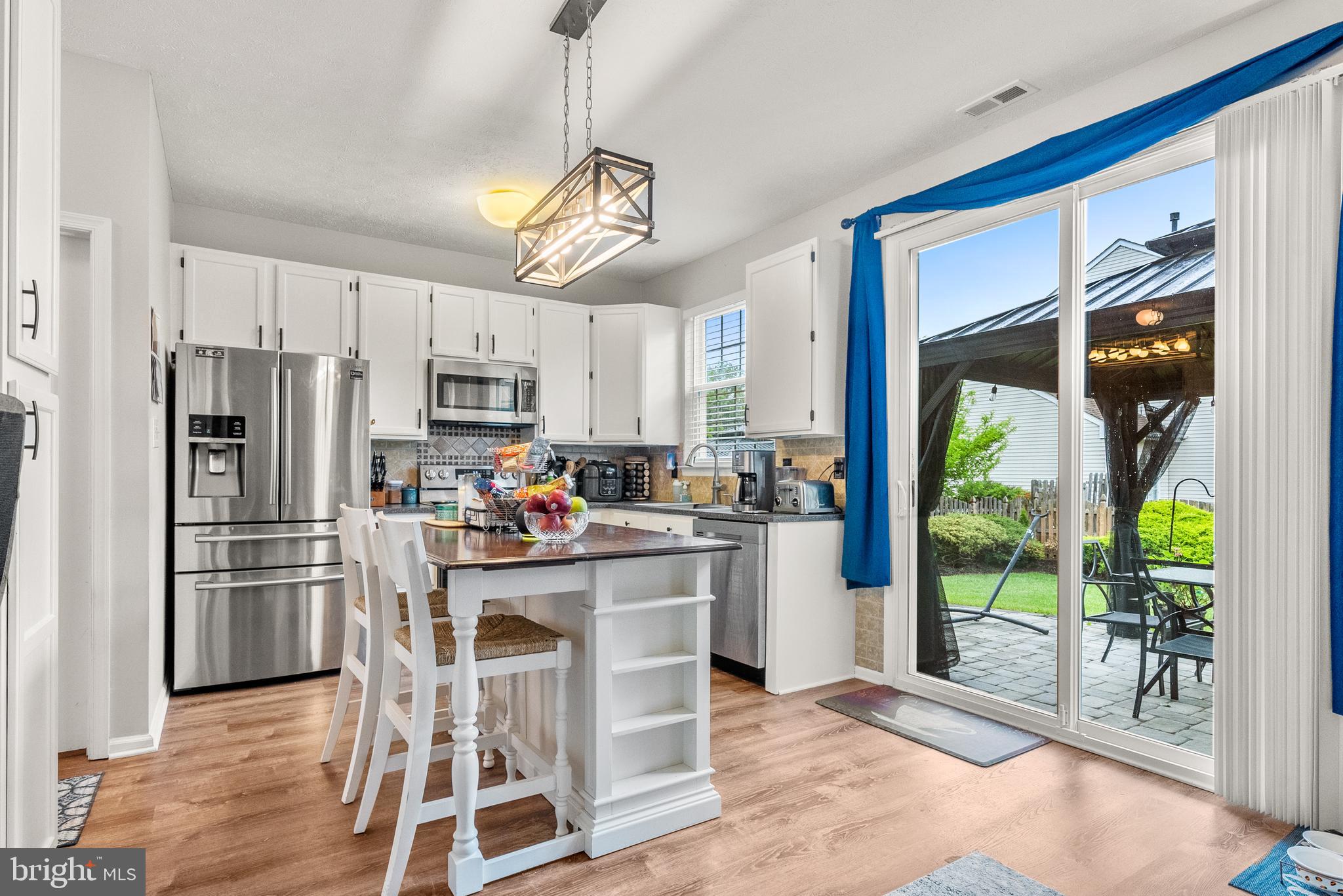 154 Sharpless Boulevard Westampton, NJ 08060 - Photo 8 of 22 a kitchen with refrigerator cabinets and wooden floor