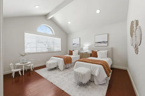 a bedroom with two beds and a window