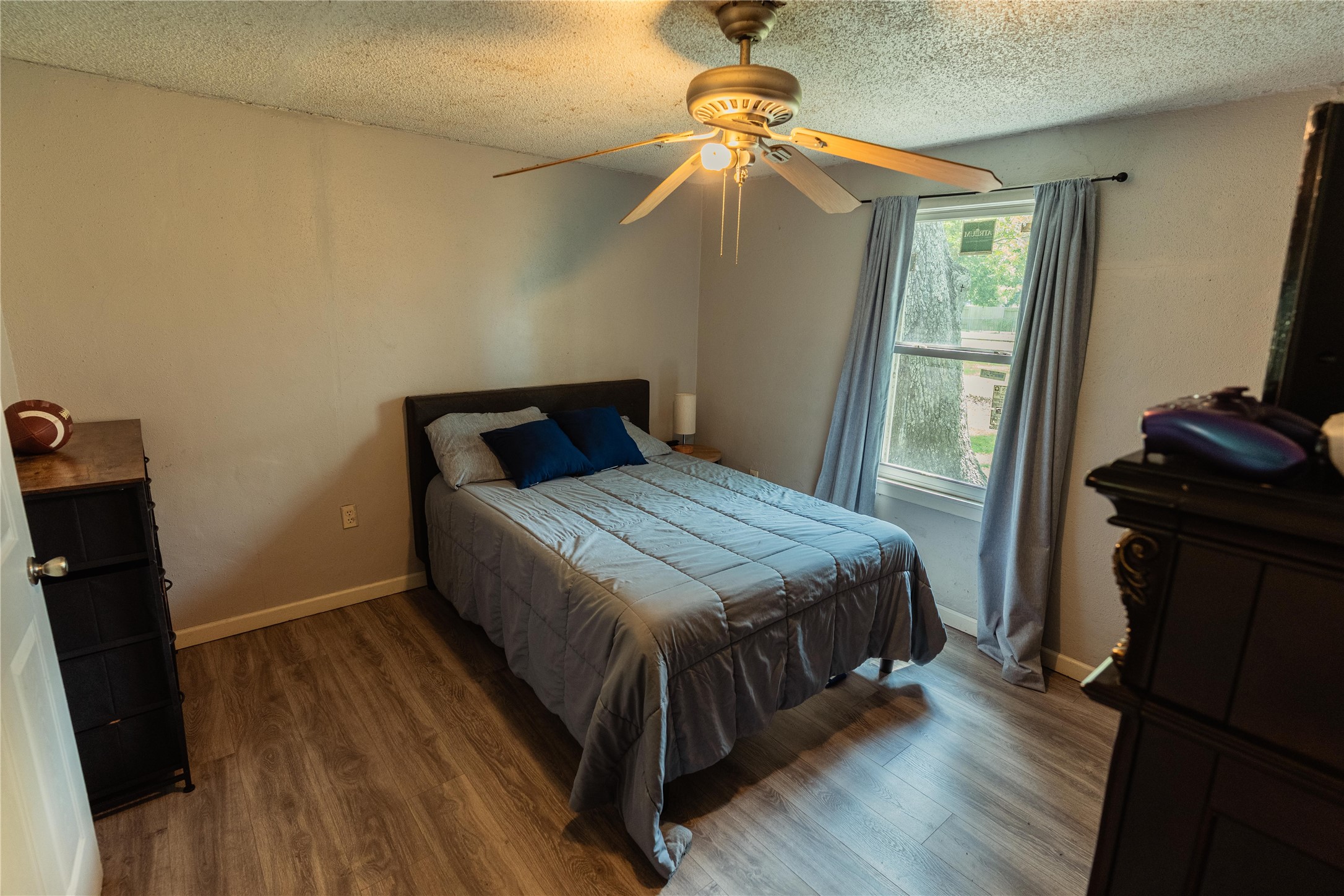 417 Hardy Street Clute, TX 77531 - Photo 15 of 28 a bedroom with a bed and wooden floor