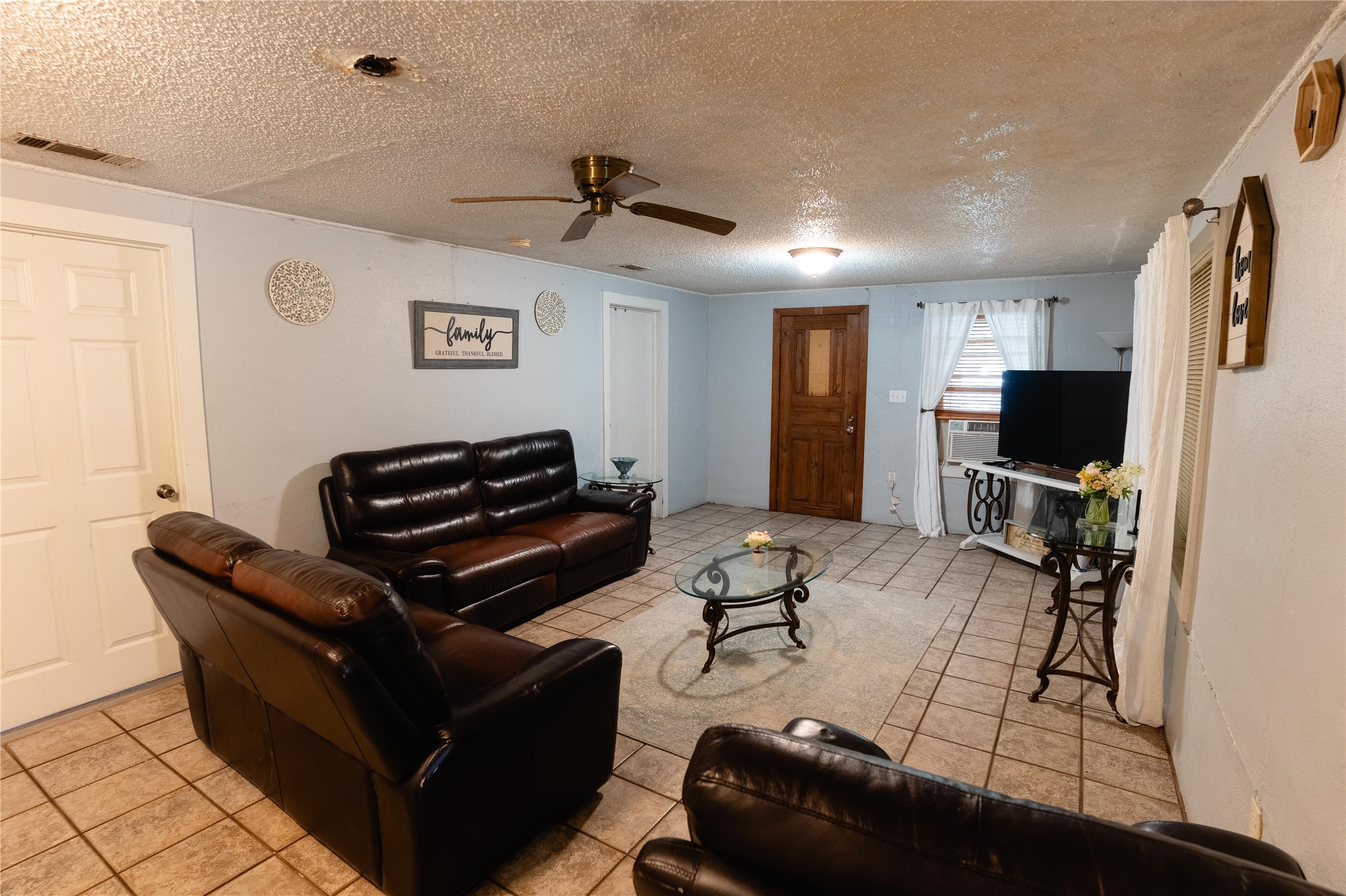 417 Hardy Street Clute, TX 77531 - Photo 18 of 28 a living room with furniture and a flat screen tv