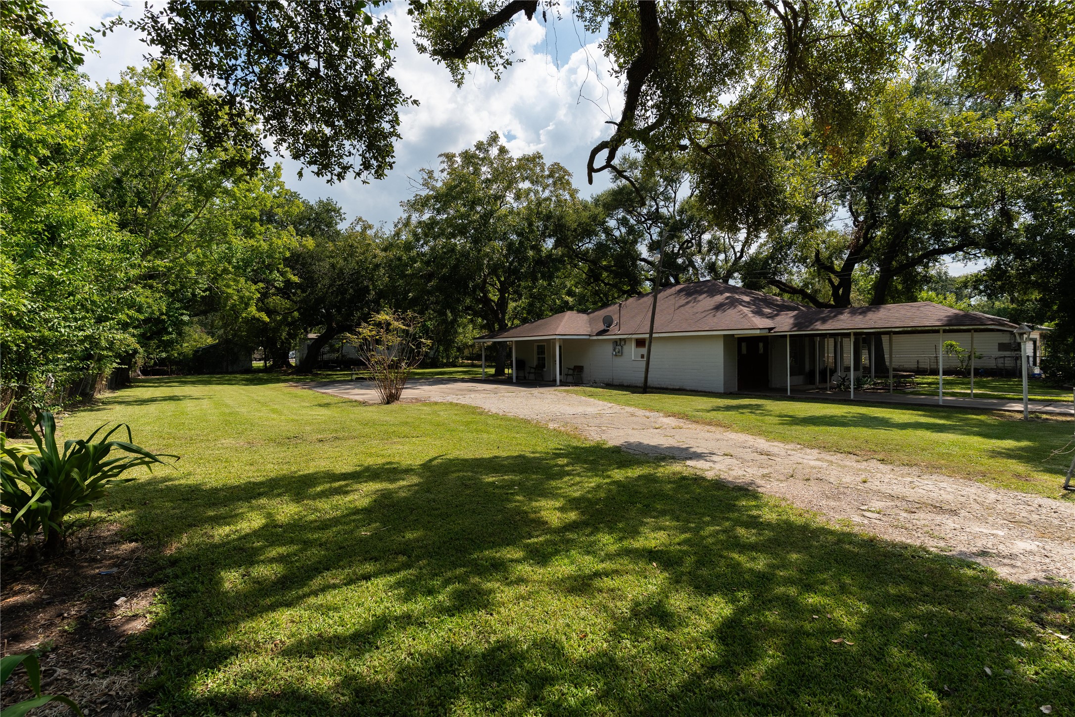 417 Hardy Street Clute, TX 77531 - Photo 25 of 28 a swimming pool with trees in the background