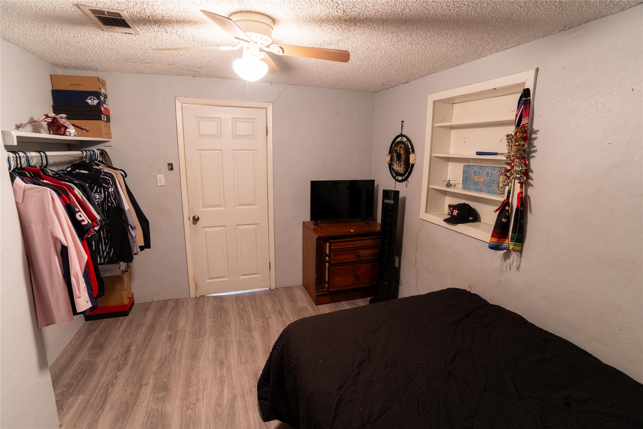 417 Hardy Street Clute, TX 77531 - Photo 7 of 28 a bedroom with a bed and a flat tv screen