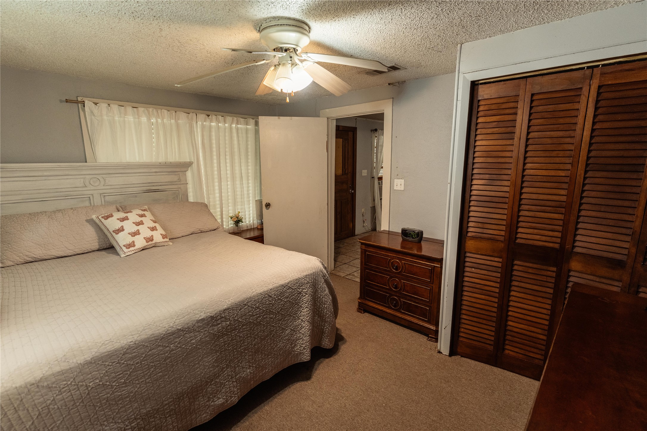 417 Hardy Street Clute, TX 77531 - Photo 9 of 28 a bedroom with a bed and a chandelier