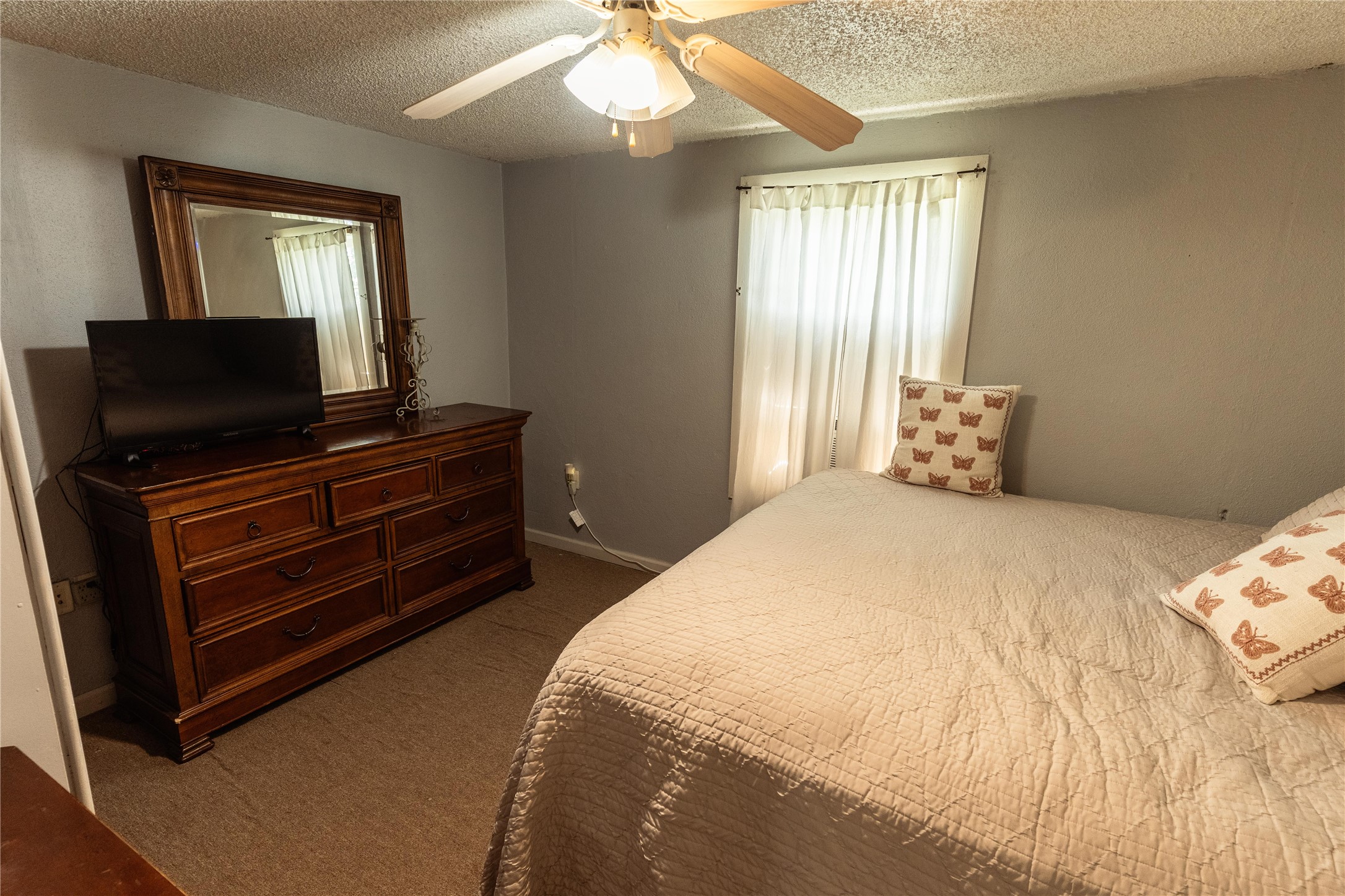 417 Hardy Street Clute, TX 77531 - Photo 10 of 28 a bedroom with a bed and a flat screen tv