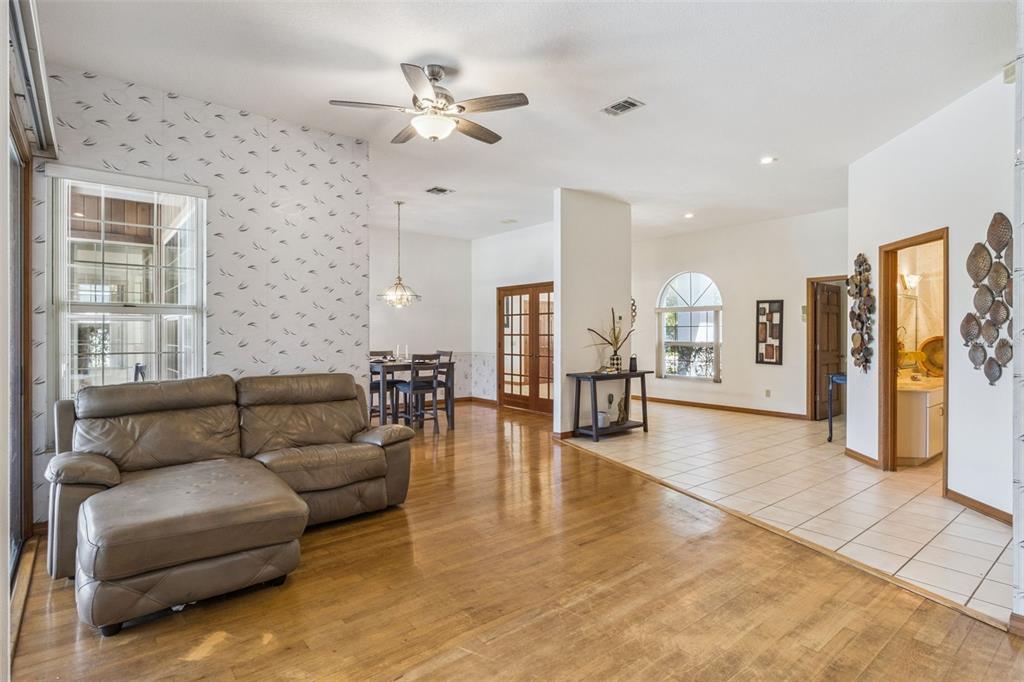 2964 Plantation Road Winter Haven, FL 33884 - Photo 9 of 42 a living room with furniture and wooden floor
