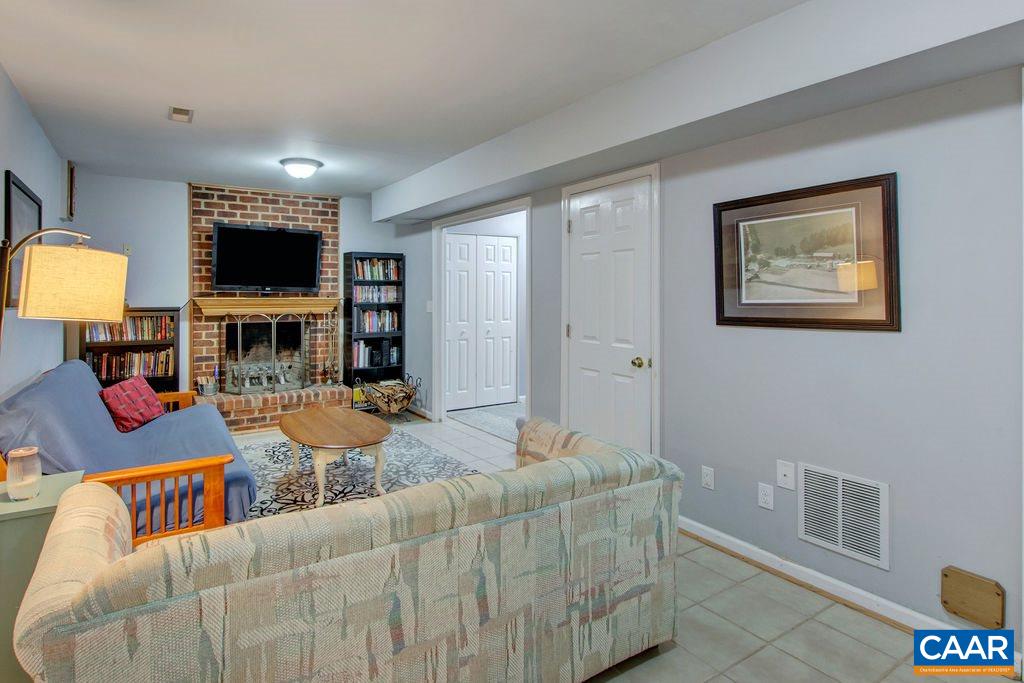 809 Harris Road Charlottesville, VA 22902 - Photo 28 of 39 a living room with fireplace and a flat screen tv