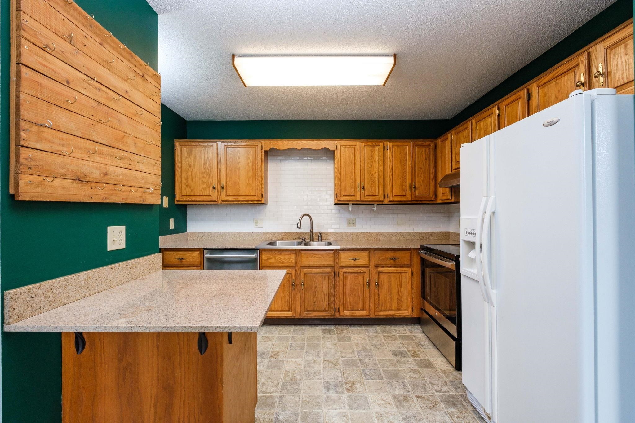 2062 Rosedale Court Harrisonburg, VA 22801 - Photo 8 of 24 a kitchen with stainless steel appliances granite countertop a sink and a refrigerator