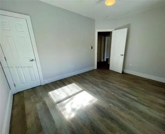 a view of an empty room and wooden floor