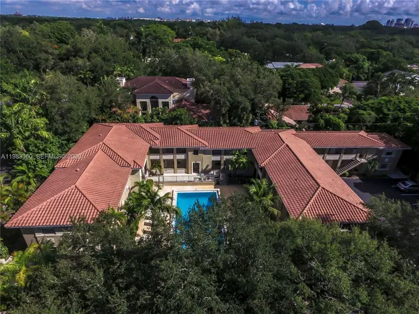 an aerial view of house with yard and mountain view in back
