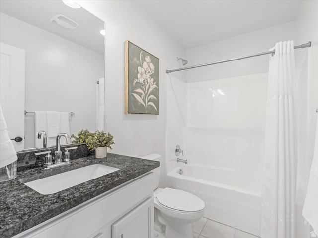 11759 South Watercourse Road South Jordan, UT 84009 - Photo 16 of 33 Bathroom featuring a white vanity with a dark speckled countertop, undermount sink, and polished chrome faucet