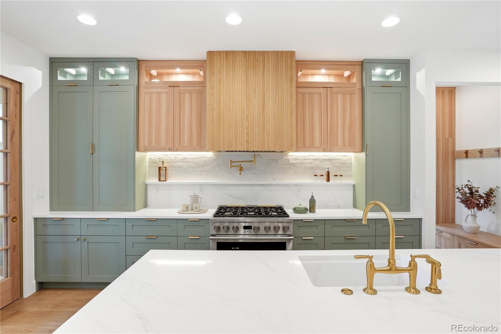 245 South Emerson Street Denver, CO 80209 - Photo 13 of 49 a kitchen with a sink and a stove top oven
