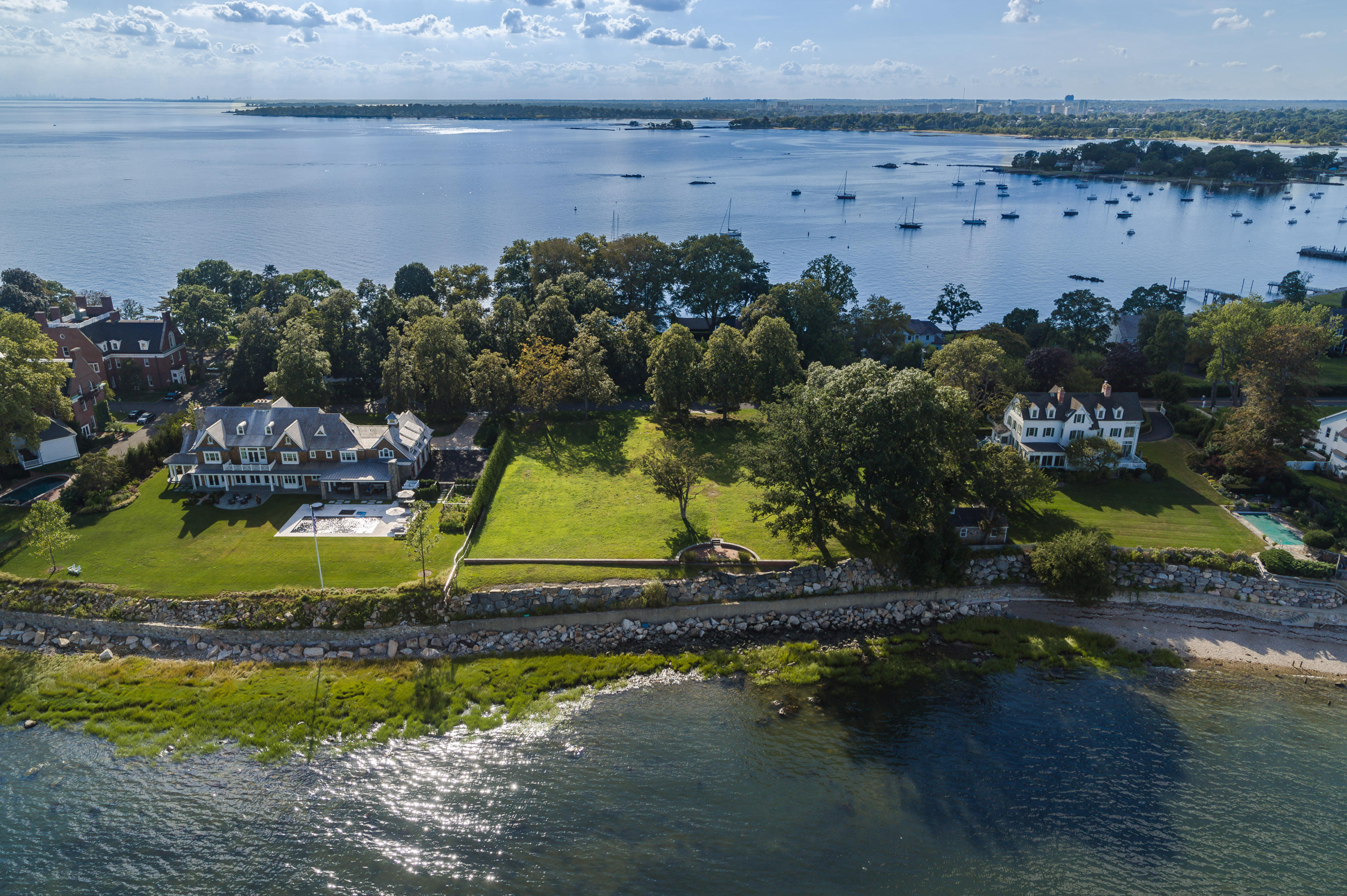 241 Long Neck Point Road Darien, CT 06820 - Photo 9 of 29 an aerial view of a house with a garden and lake view