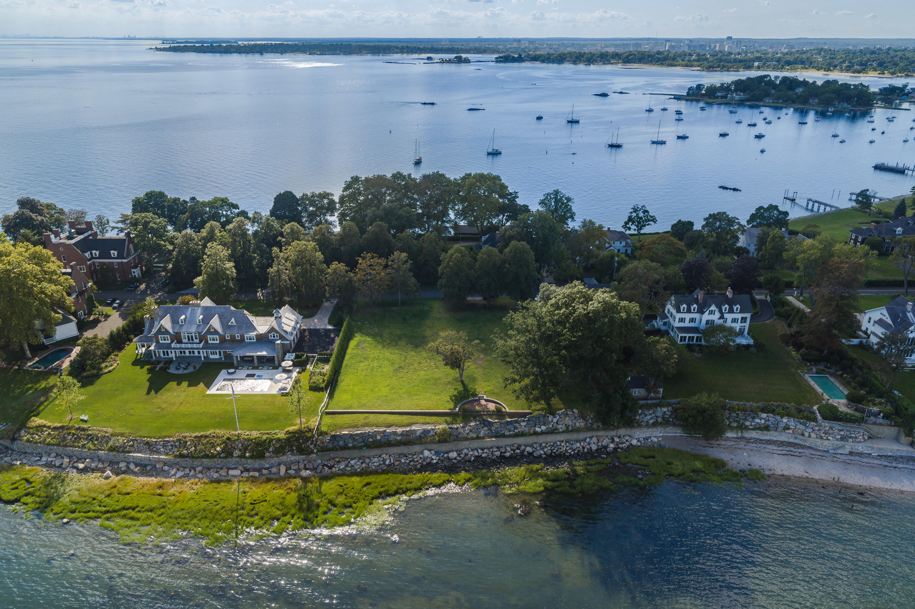 241 Long Neck Point Road Darien, CT 06820 - Photo 10 of 29 a view of swimming pool with a yard and outdoor seating