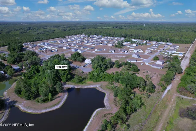 an aerial view of a house with a yard