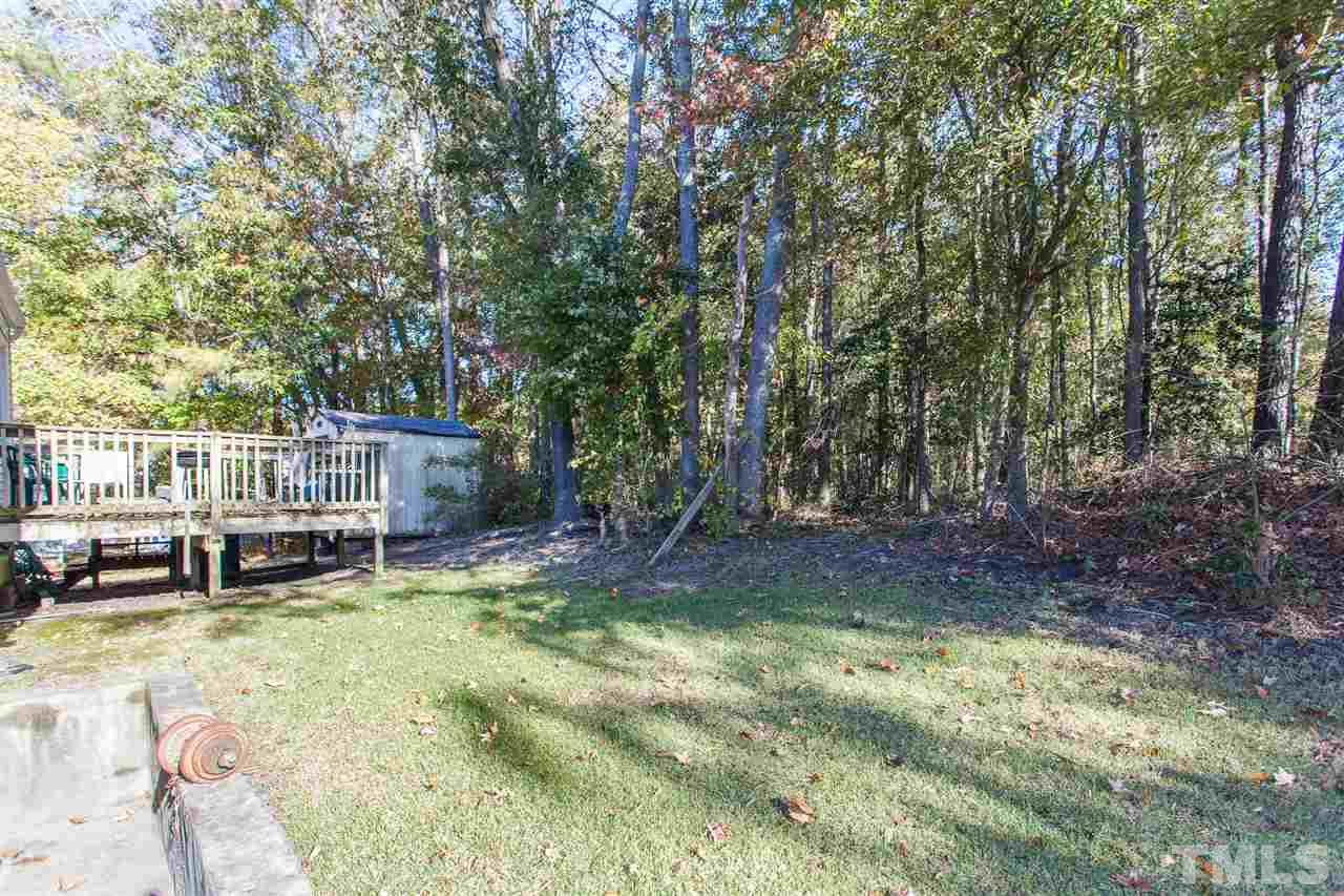8348 Wynewood Court Raleigh, NC 27616 - Photo 22 of 23 a view of a backyard with a table and chairs