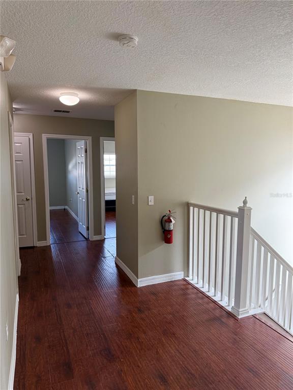 1037 Berkeley Drive Kissimmee, FL 34744 - Photo 12 of 38 a view of a hallway with wooden floor