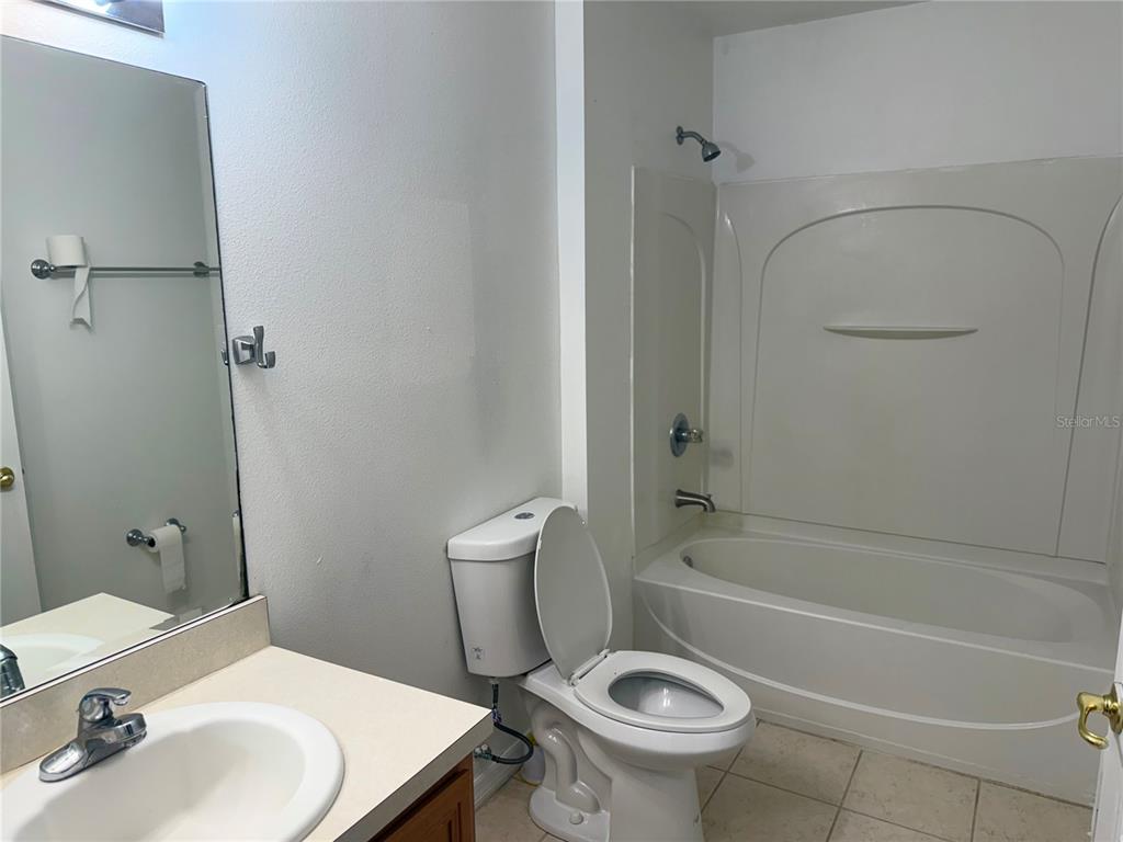 1037 Berkeley Drive Kissimmee, FL 34744 - Photo 18 of 38 a bathroom with a sink a toilet and shower