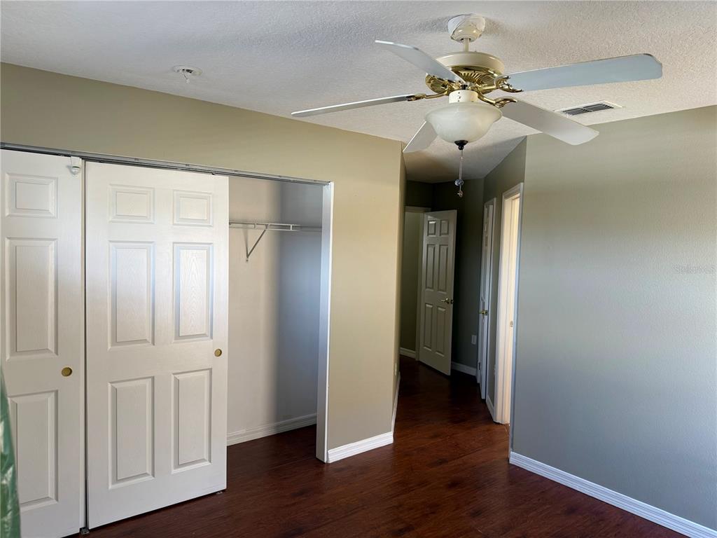 1037 Berkeley Drive Kissimmee, FL 34744 - Photo 19 of 38 wooden floor in an empty room