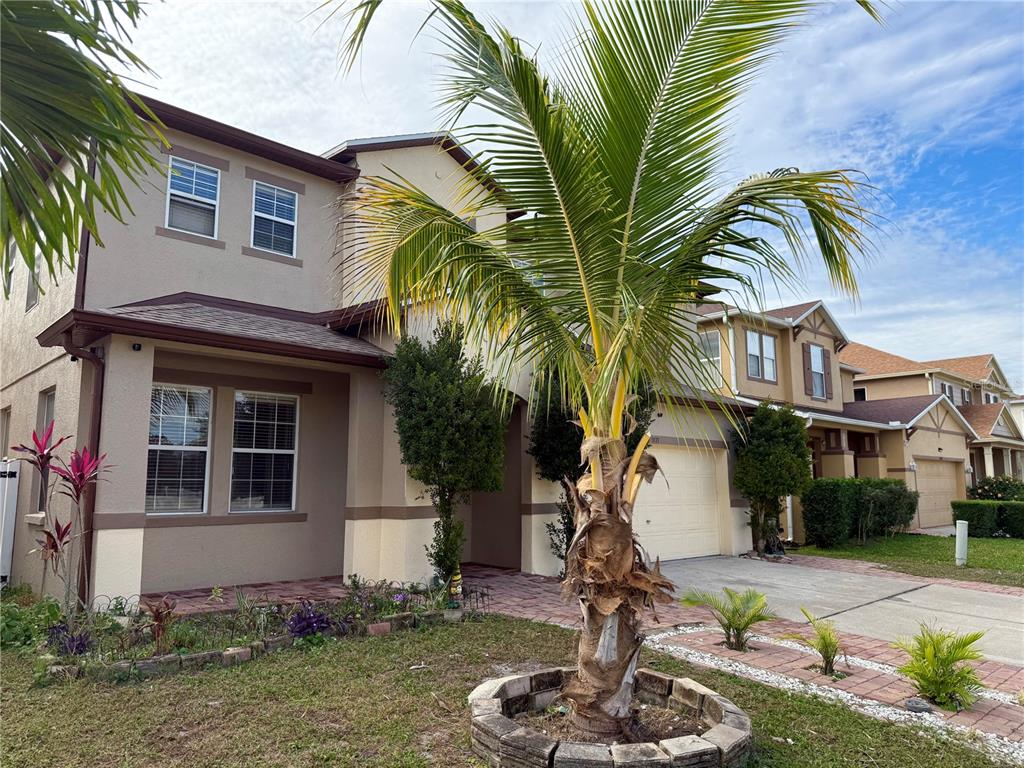 1037 Berkeley Drive Kissimmee, FL 34744 - Photo 2 of 38 a front view of a house with a yard