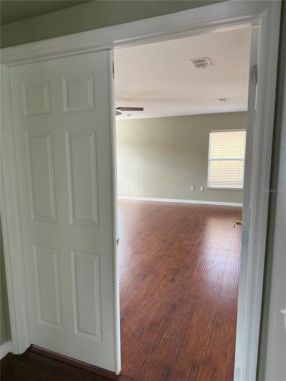 1037 Berkeley Drive Kissimmee, FL 34744 - Photo 28 of 38 a view of empty room with wooden floor