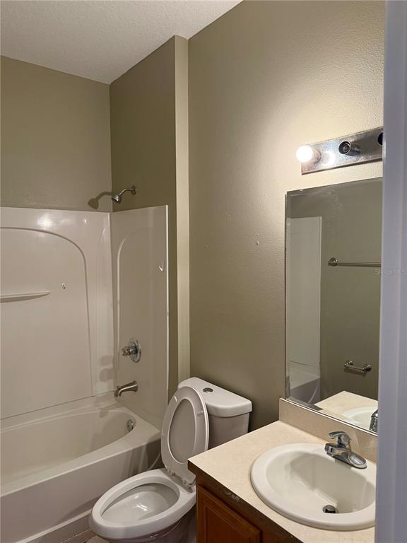 1037 Berkeley Drive Kissimmee, FL 34744 - Photo 32 of 38 a bathroom with a toilet sink and bathtub